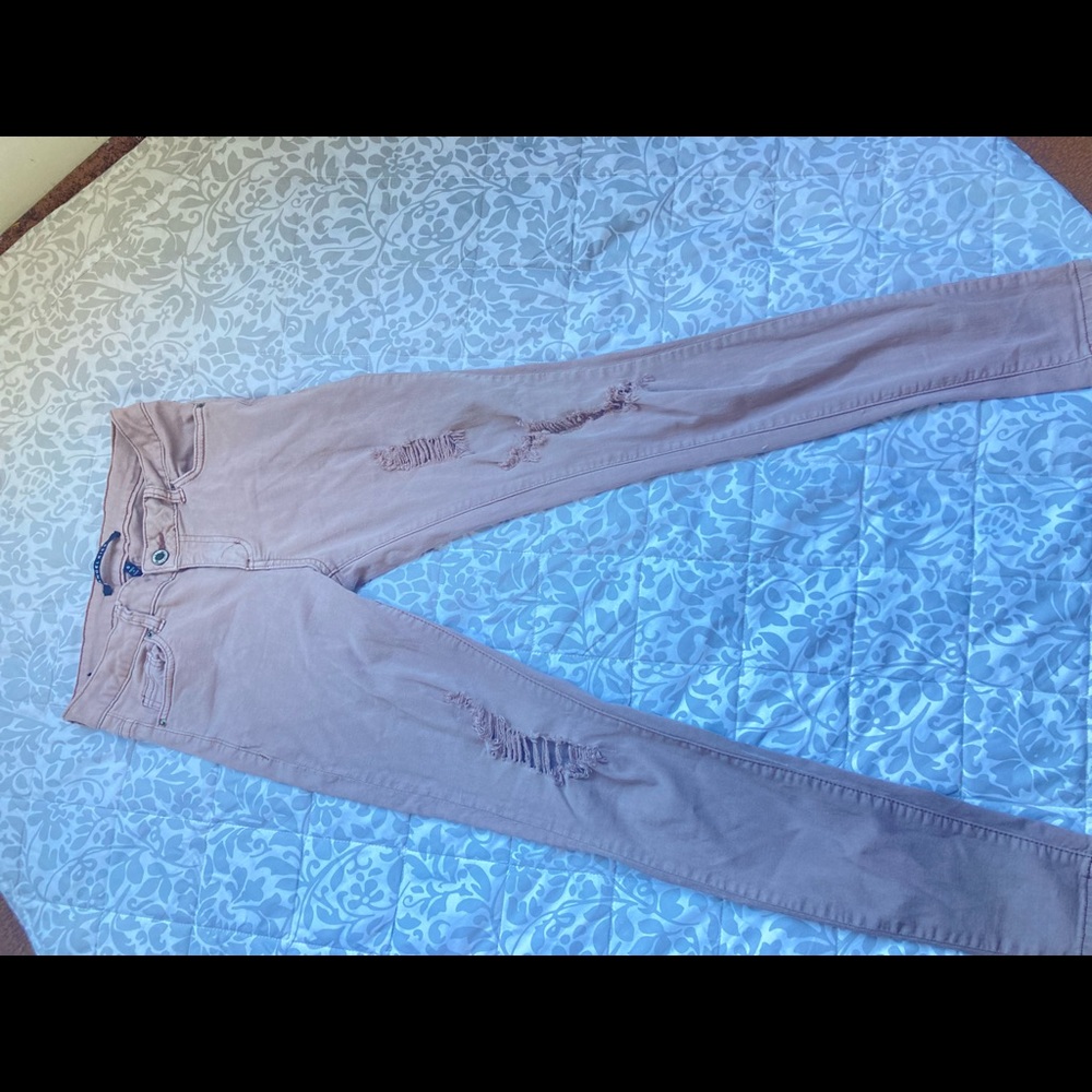 Light pink ripped jeans.